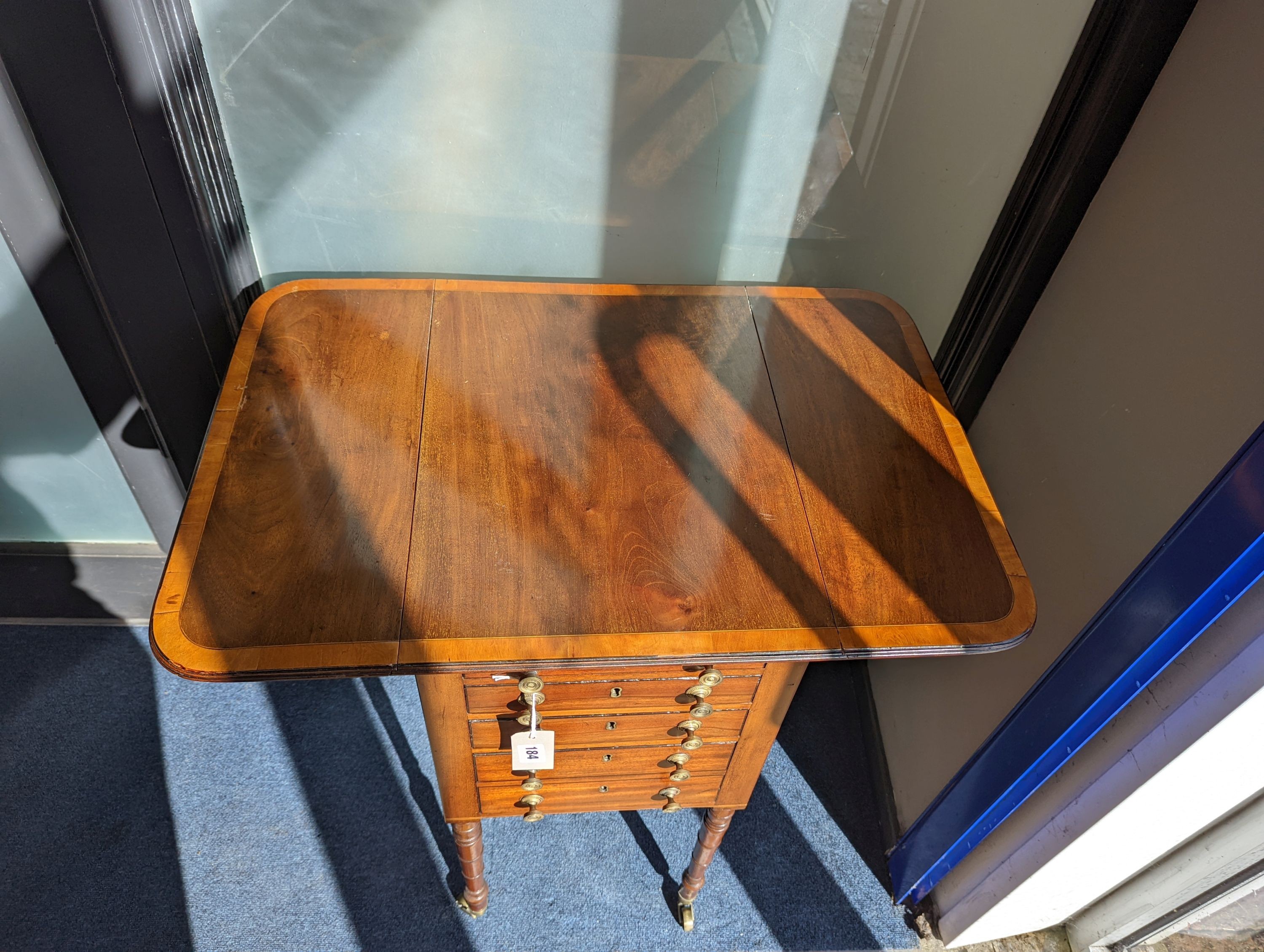 A Regency satinwood banded mahogany drop flap work table, width 69cm extended, depth 46cm, height 76cm